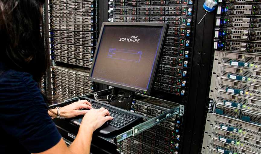 Picture of woman using computer in server room